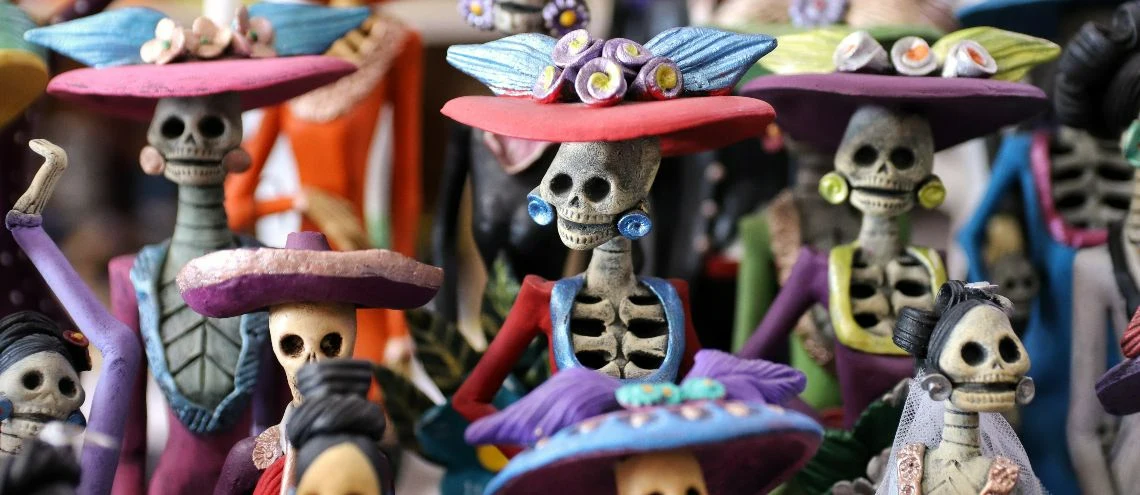 Skeleton toys in colorful dresses and hats